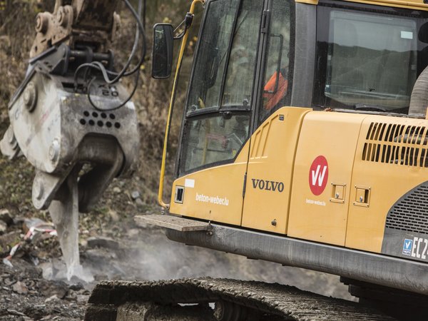 Excavator with the corporate identity logo on the side